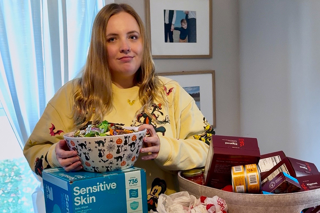 This photo provided by Taylor Martin shows her with shelf-stable foods and other supplies to give out to trick-or-treaters on Wednesday, Oct. 29, 2025, in La Porte, Ind. (Courtesy Taylor Martin via AP)