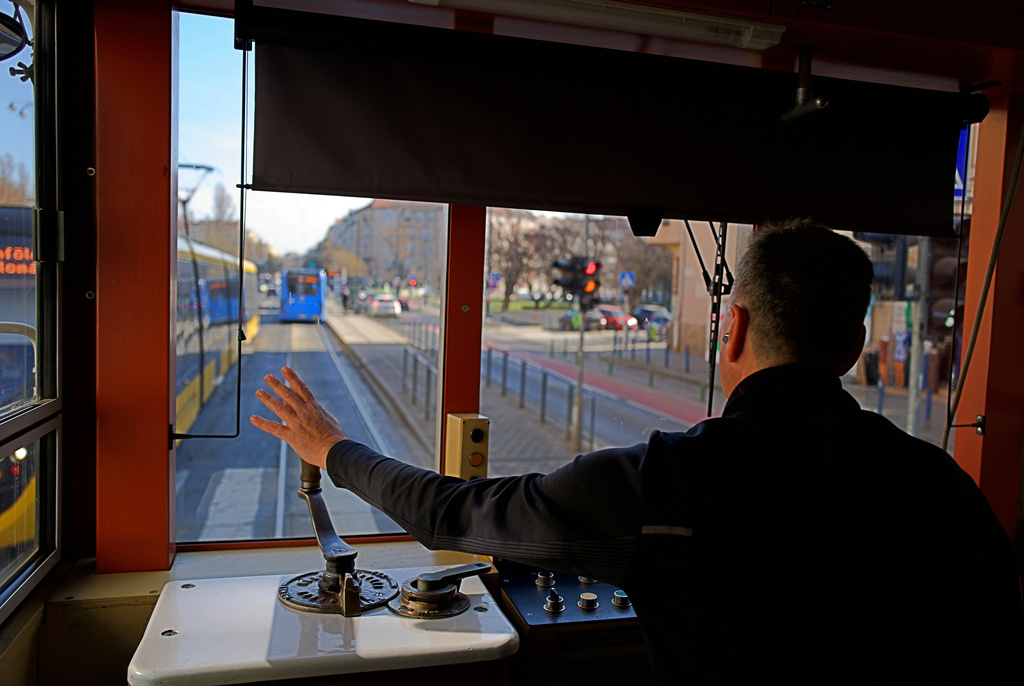 A driver waves while operating a century-old freight tram in Budapest, Hungary on Thursday, March 12, 2026. (AP Photo/Bela Szandelszky)