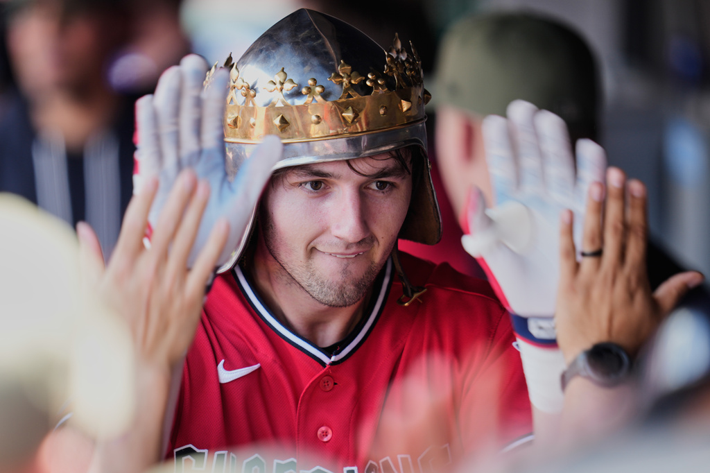 Cleveland Guardians' Chase DeLauter is congratulated in the dugout after hitting a home run in the first inning of a baseball game against the Cincinnati Reds in Cleveland, Sunday, May 17, 2026. (AP Photo/Sue Ogrocki)