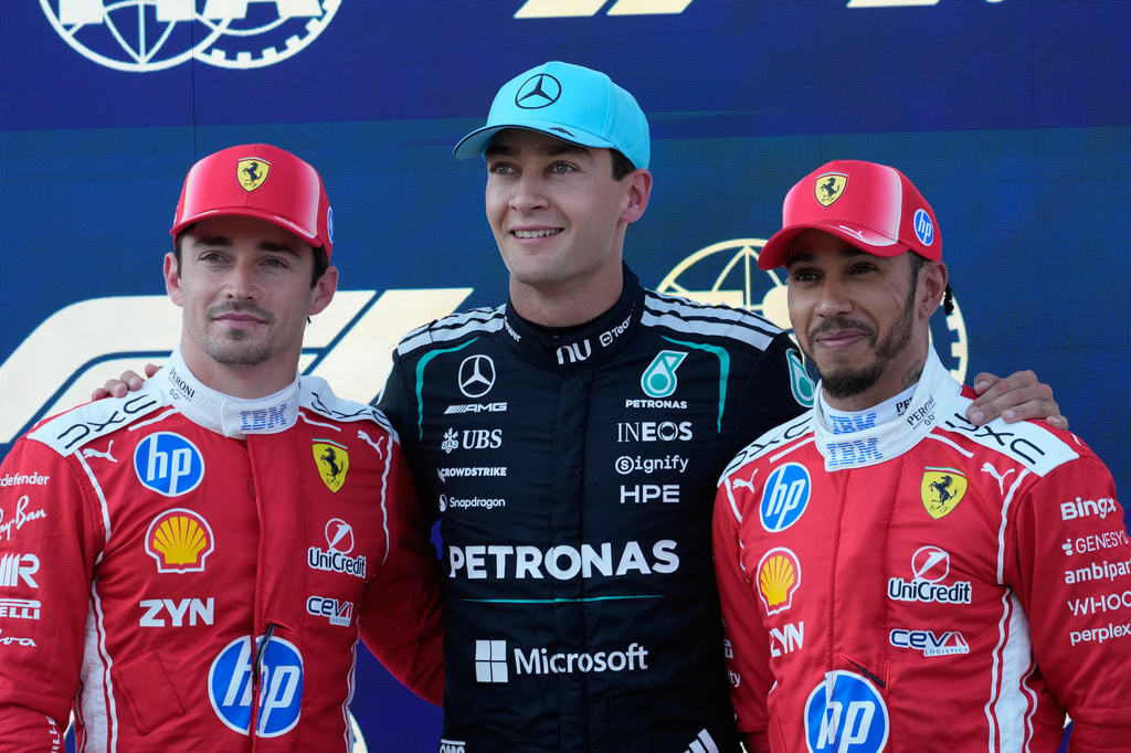 Mercedes driver George Russell of Britain, center, pole position, is flanked by second fastest time Ferrari driver Charles Leclerc of Monaco, led an third fastest time Ferrari driver Lewis Hamilton of Britain after the qualifying session ahead of the Austrian F1 Grand Prix, in Spielberg, Austria, Saturday, June 27, 2026. (AP Photo/Darko Bandic)