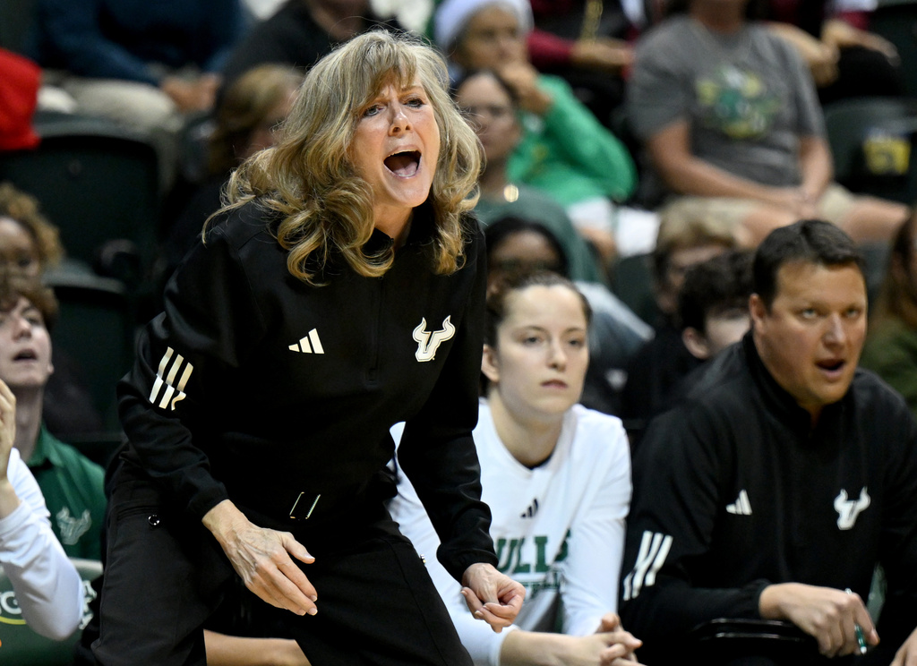 South Florida interim head coach Michele Woods-Baxter yells to her team during the first half of an NCAA college basketball game against South Carolina, Thursday, Dec. 18, 2025, in Tampa, Fla. (AP Photo/Jason Behnken)