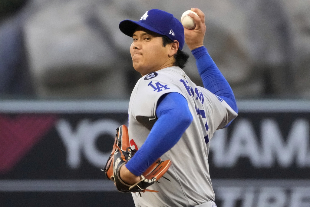 Los Angeles Dodgers starting pitcher Shohei Ohtani throws to the plate during the third inning of a baseball game against the Los Angeles Angels, Wednesday, Aug. 13, 2025, in Anaheim, Calif. (AP Photo/Mark J. Terrill)