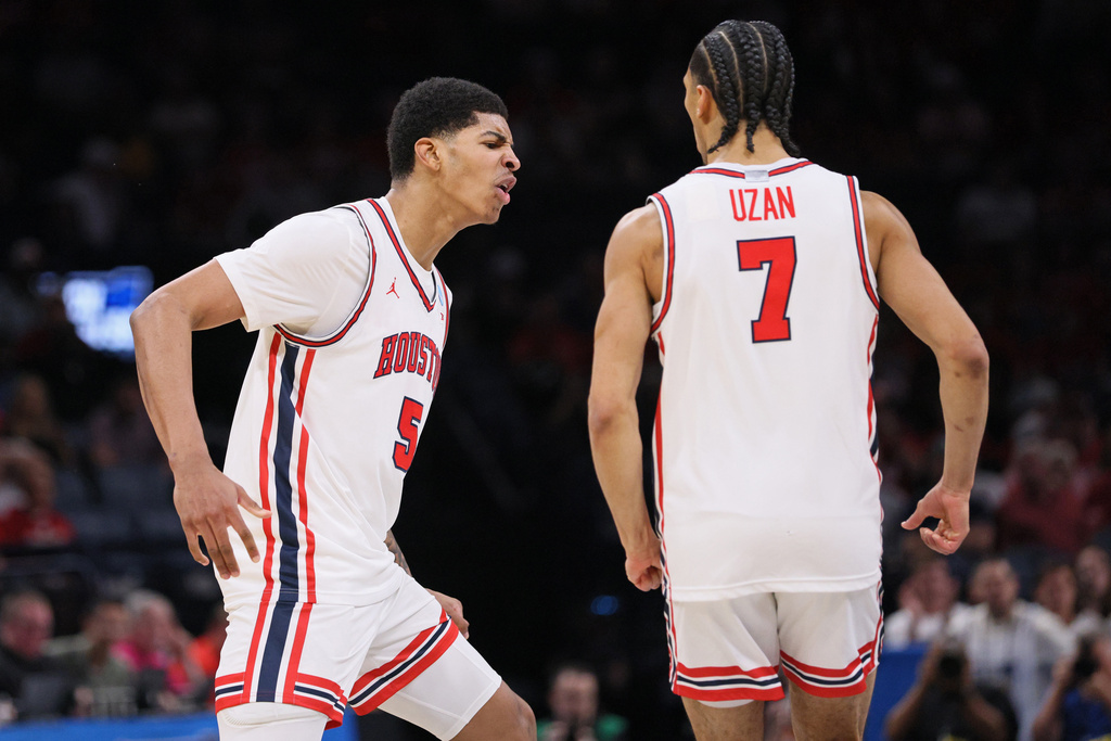 Houston center Chris Cenac Jr. (5) reacts next to guard Milos Uzan (7) during the first half against Texas A&M in the second round of the NCAA college basketball tournament Saturday, March 21, 2026, in Oklahoma City. (AP Photo/Nate Billings)