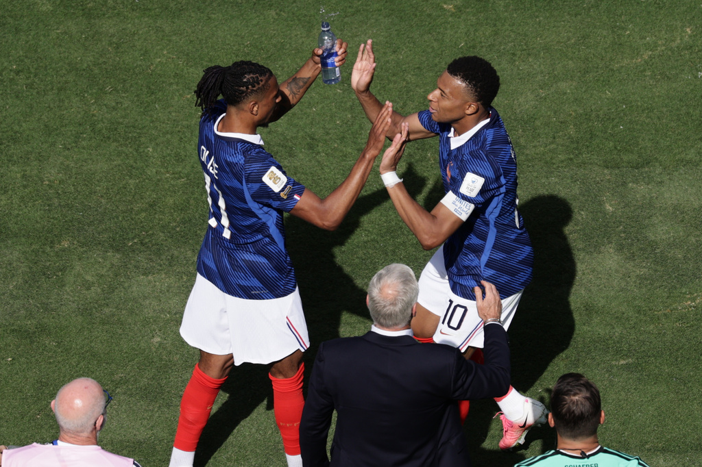 France's Michael Olise, left, and Kylian Mbappe celebrate after scoring the opening goal during the World Cup Group I soccer match between France and Senegal in East Rutherford, N.J., near New York, Tuesday, June 16, 2026. (AP Photo/Adam Hunger)