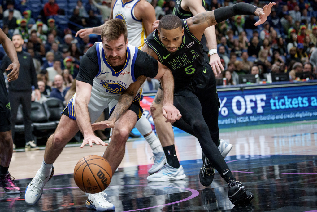 New Orleans Pelicans guard Dejounte Murray battles Golden State Warriors guard Pat Spencer (61) during the first half of an NBA basketball game in New Orleans, Tuesday, Feb. 24, 2026. (AP Photo/Matthew Hinton)