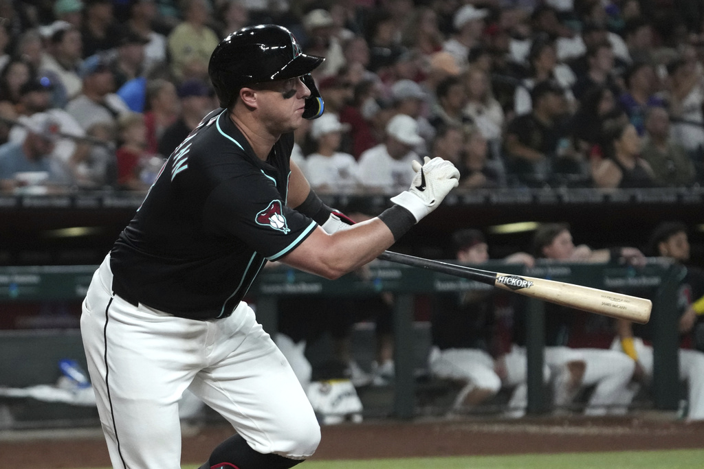 Arizona Diamondbacks' James McCann hits an RBI double against the Philadelphia Phillies in the sixth inning of a baseball game, Saturday, Sept. 20, 2025, in Phoenix. (AP Photo/Rick Scuteri)