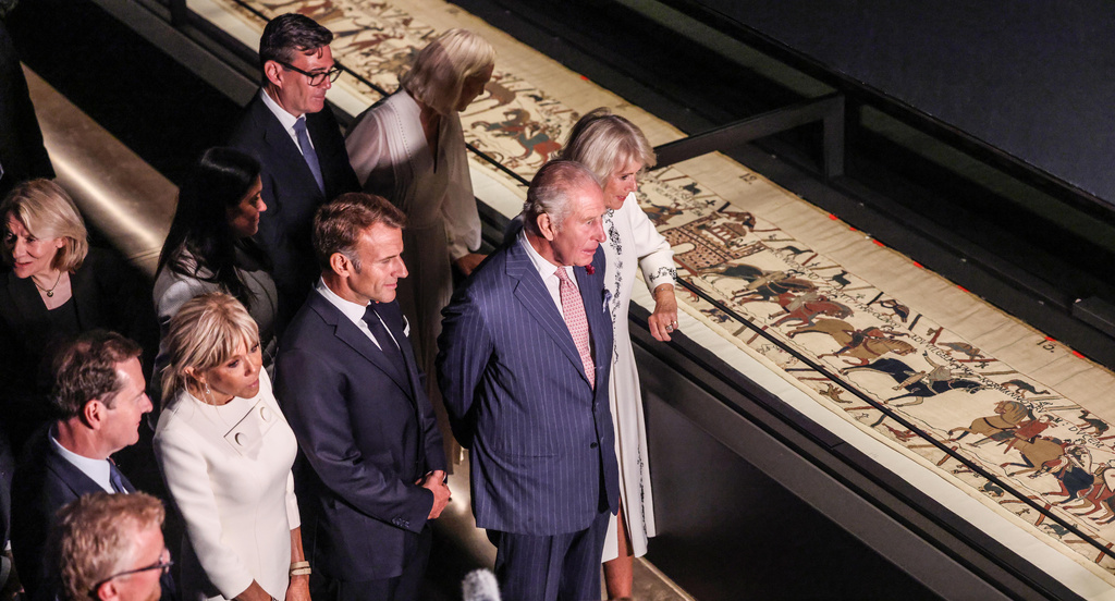 Britain's King Charles III and Queen Camilla, accompanied by The President of France Emmanuel Macron and Brigitte Macron, the Prime Minister, Andy Burnham and his wife Marie-France Van-Heel, view the Bayeux Tapestry Exhibition at the British Museum in London Wednesday, Sept. 2, 2026. (Richard Pohle, Pool Photo via AP)
