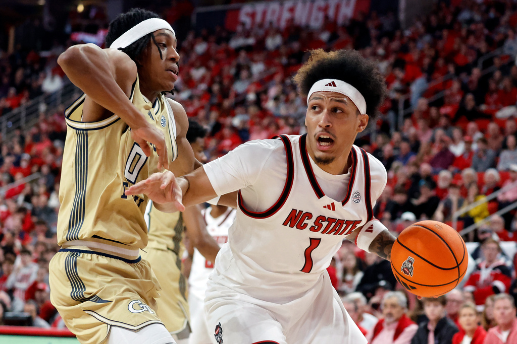 North Carolina State's Darrion Williams (1) drives the ball around Georgia Tech's Akai Fleming (0) during the first half of an NCAA college basketball game in Raleigh, N.C., Saturday, Jan. 17, 2026. (AP Photo/Karl DeBlaker)