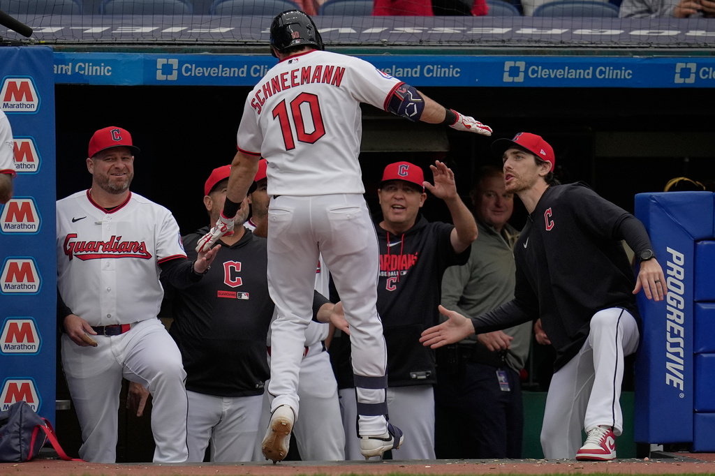 Cleveland Guardians' Daniel Schneemann (10) is congratulated as he returns to the dugout after hitting a two-run home run in the fifth inning of a baseball game against the Tampa Bay Rays in Cleveland, Monday, April 27, 2026. (AP Photo/Sue Ogrocki)
