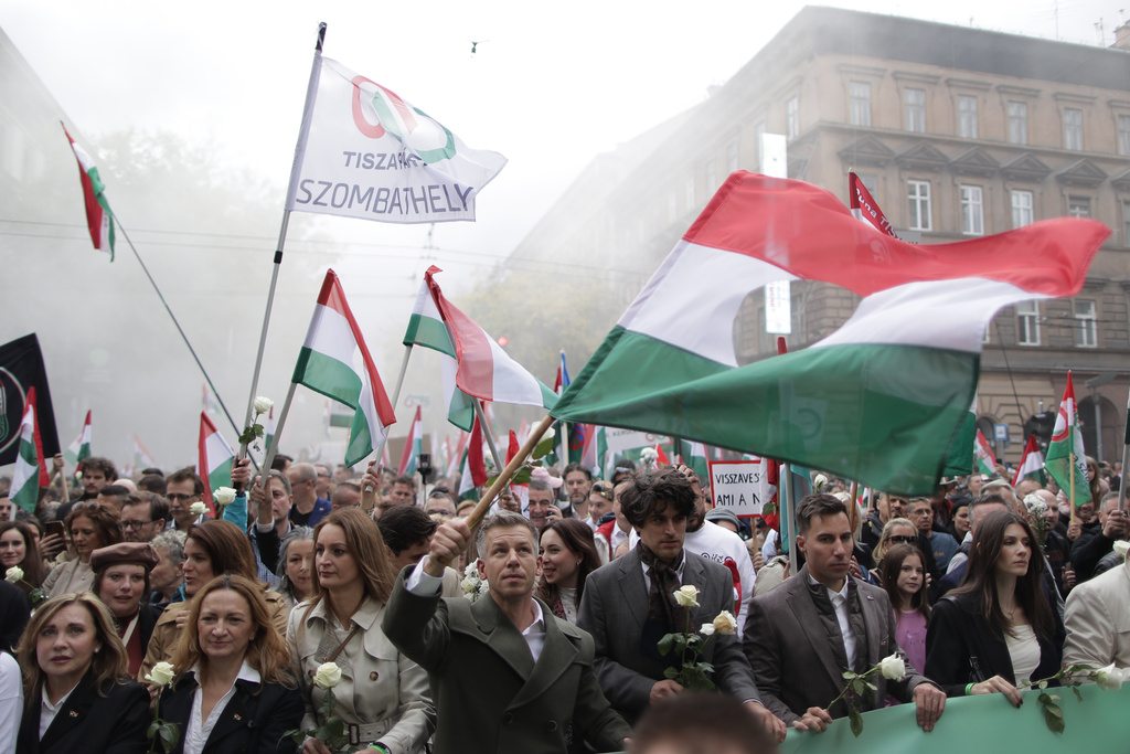 The leader of the Hungarian opposition TISZA party, Peter Magyar, foreground and center, rallies during a demonstration marking the 69th anniversary of the outbreak of Hungary's 1956 revolution against communist rule and the Soviet Union, in Budapest, Hungary, Thursday, Oct. 23, 2025. (AP Photo/Rudolf Karancsi)