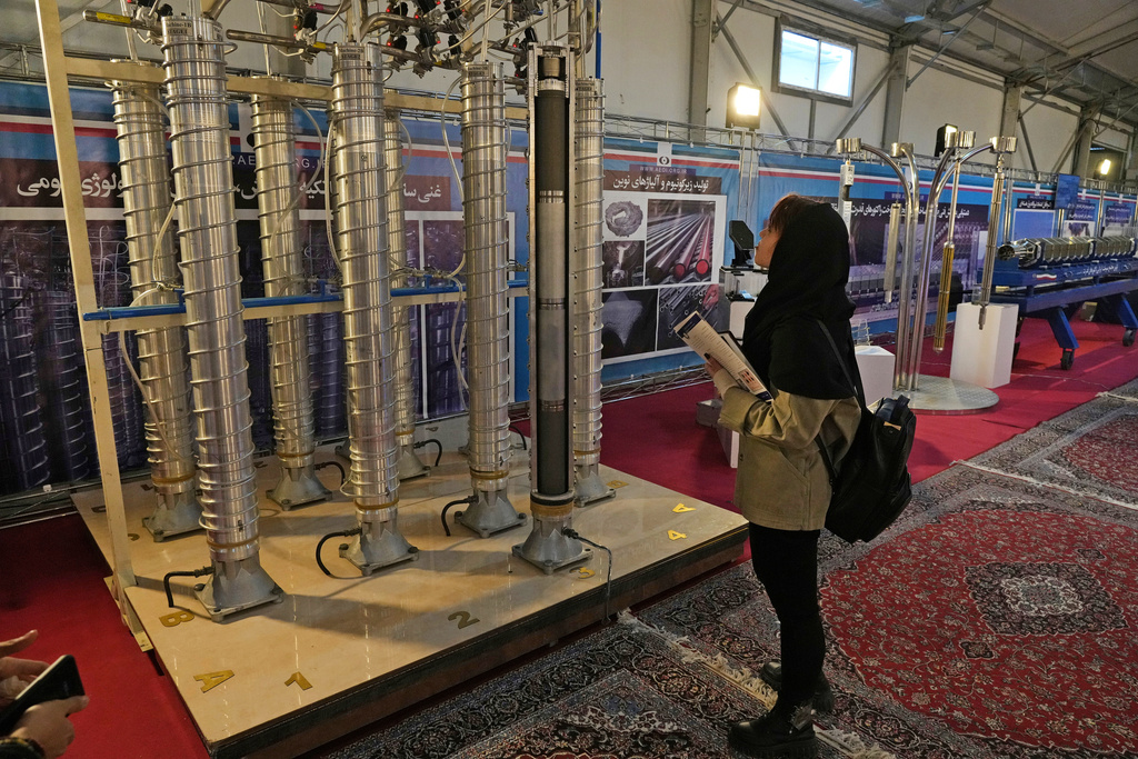 FILE -A student looks at Iran's domestically built centrifuges in an exhibition of the country's nuclear achievements, in Tehran, Iran, Wednesday, Feb. 8, 2023. (AP Photo/Vahid Salemi, File)