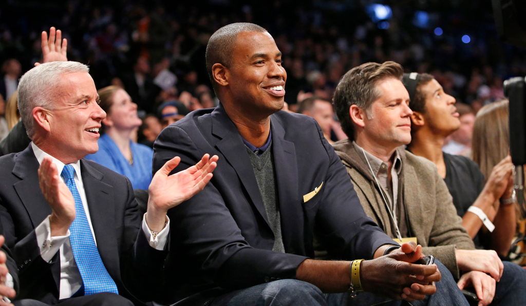 FILE - Spectators applaud Jason Collins, center, during the first half of a basketball game between the Milwaukee Bucks and the Brooklyn Nets on Wednesday, Nov. 19, 2014, in New York. (AP Photo/Kathy Willens, file)