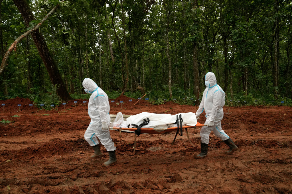 Nepal's paramilitary force personnel carry the body of a flash flood victim for burial at a mass burial site in Chitwan, Nepal, Monday, Aug. 31, 2026. (AP Photo/Dar Yasin)