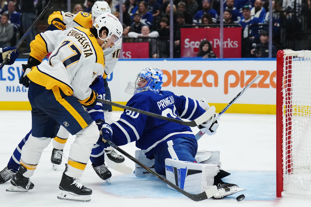 Toronto Maple Leafs goaltender Cayden Primeau (30) makes a save on Nashville Predators' Luke Evangelista (77) during third period NHL hockey action in Toronto on Tuesday, Oct. 14, 2025. (Nathan Denette/The Canadian Press via AP)
