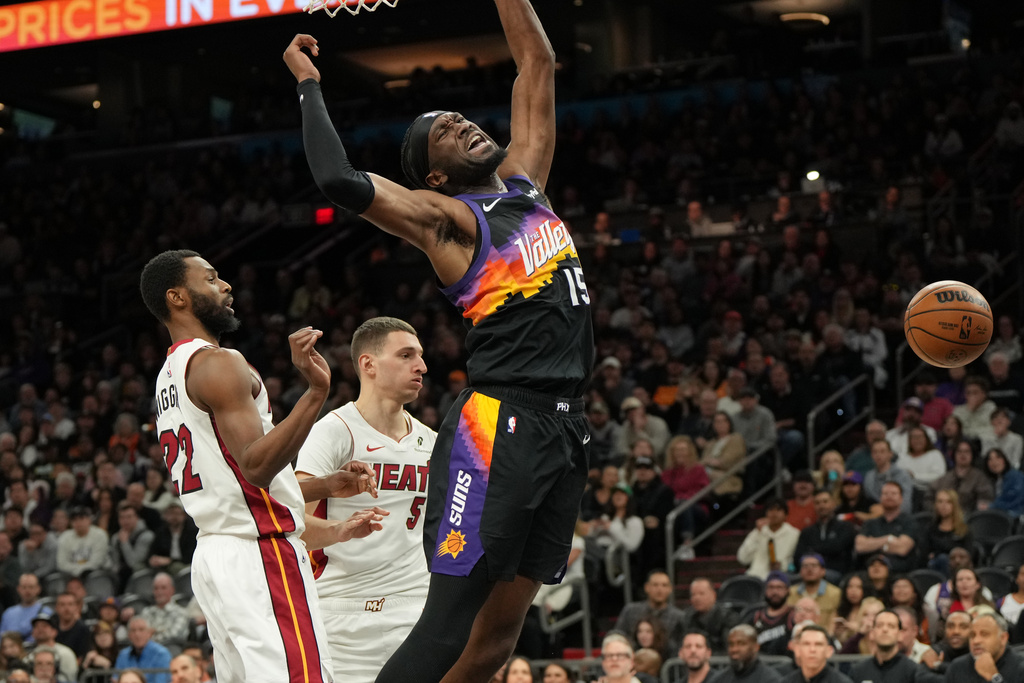 Phoenix Suns center Mark Williams reacts (15) after being fouled by Miami Heat forward Andrew Wiggins, left, during the second half of an NBA basketball game, Sunday, Jan. 25, 2026, in Phoenix. (AP Photo/Rick Scuteri)