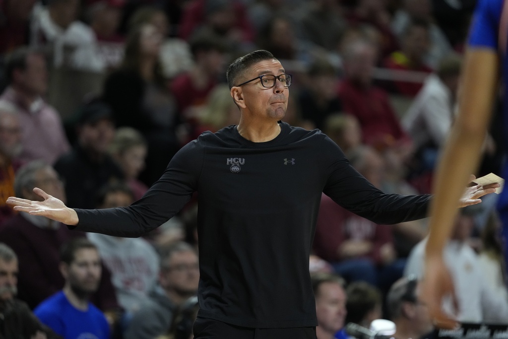 Houston Christian head coach Craig Doty directs his team during the first half of an NCAA college basketball game against Iowa State, Monday, Dec. 29, 2025, in Ames, Iowa. (AP Photo/Matthew Putney)
