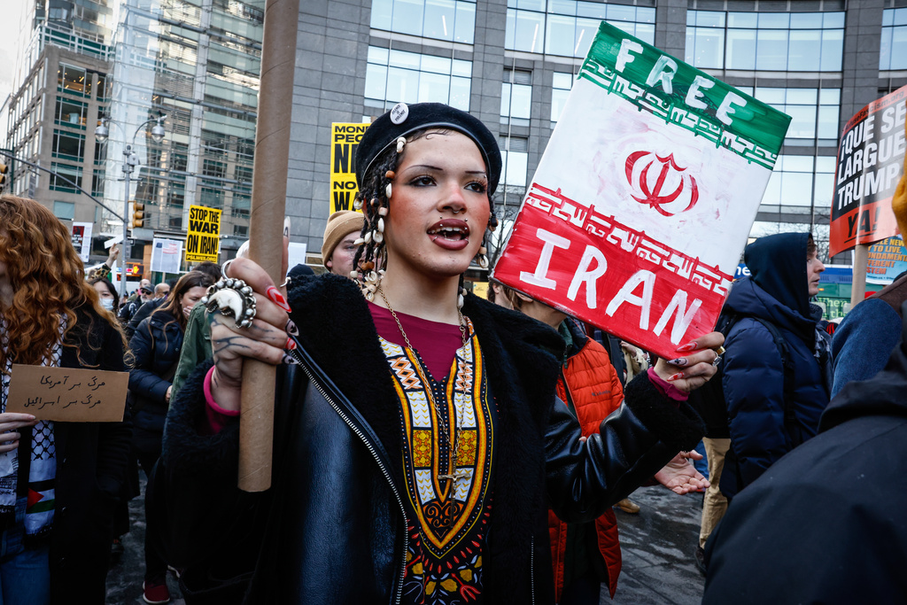 People march during a protest in New York, on Saturday, Feb. 28, 2026, against U.S. and Israeli strikes on Iran. (AP Photo/Kena Betancur)