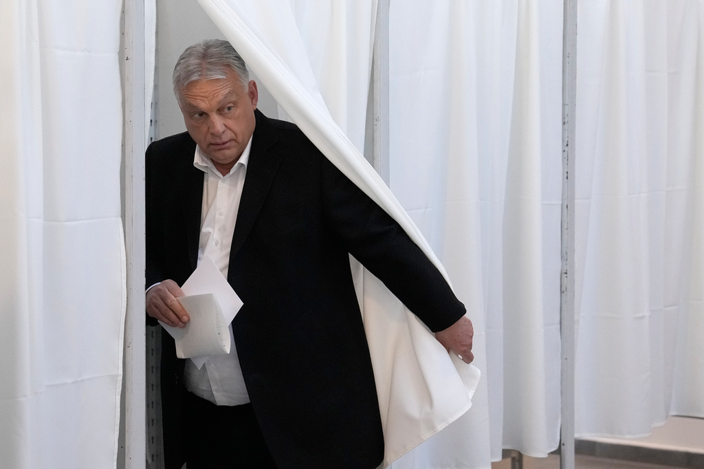 Hungary's Prime Minister Viktor Orban prepares to cast his ballot at a polling station in Budapest, Hungary, Sunday, April 12, 2026. (AP Photo/Petr David Josek)