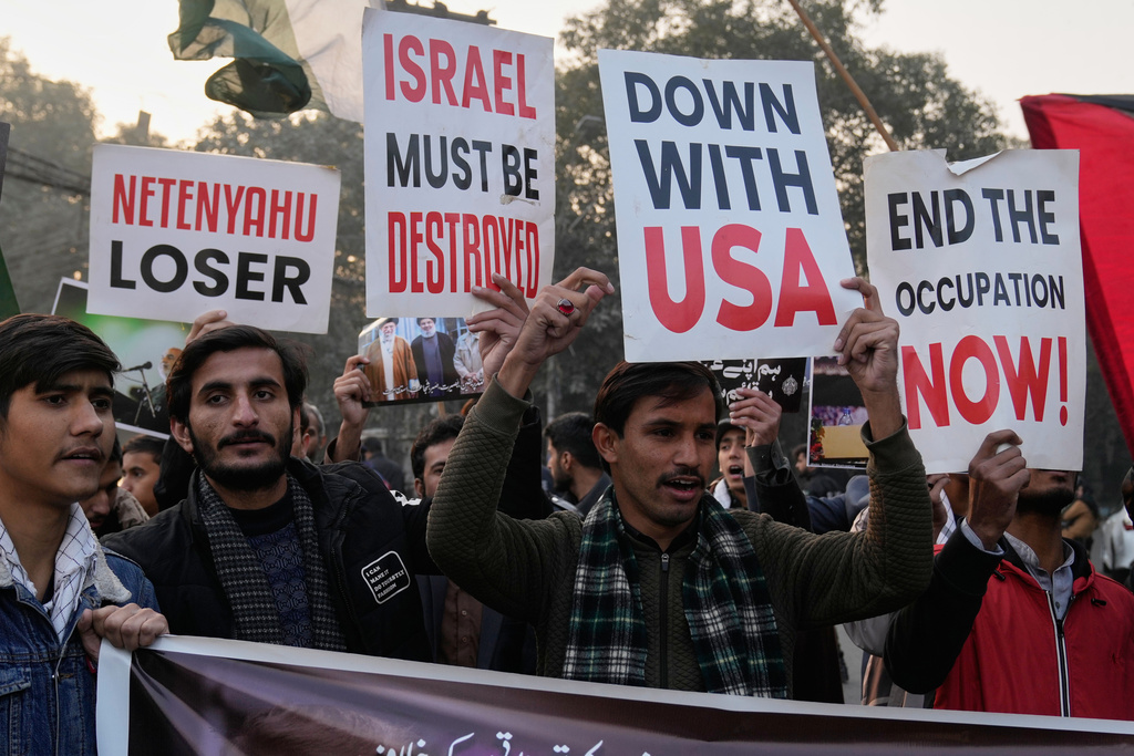 Shiite Muslims hold placards and chant slogans during a protest against the U.S. and show solidarity with Iran in Lahore, Pakistan, Sunday, Jan. 11, 2026. (AP Photo/K.M. Chaudary)