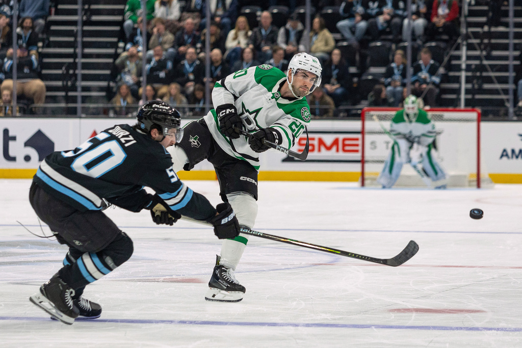Dallas Stars defenseman Kyle Capobianco, right, moves the puck against Utah Mammoth defenseman Sean Durzi during the second period of an NHL hockey game, Thursday, Jan. 15, 2026, in Salt Lake City. (AP Photo/Melissa Majchrzak)