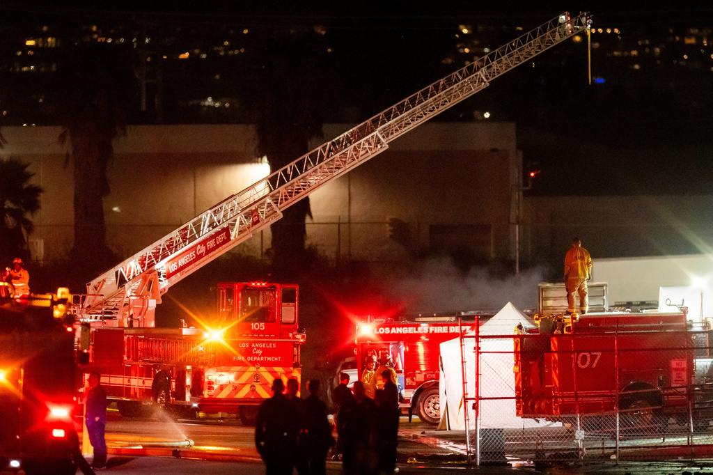 First responders work the scene after a helicopter crashed near a bus crash in Chatsworth, a neighborhood in Los Angeles, Tuesday, Sept. 15, 2026. (AP Photo/Ethan Swope)