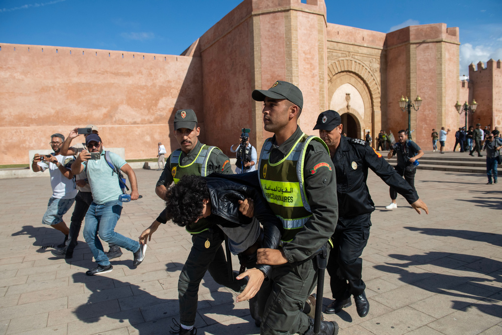 Security forces disperse and arrest protesters during a demonstration demanding healthcare and education reforms, in Rabat, Sunday, Sept. 28, 2025. (AP Photo)
