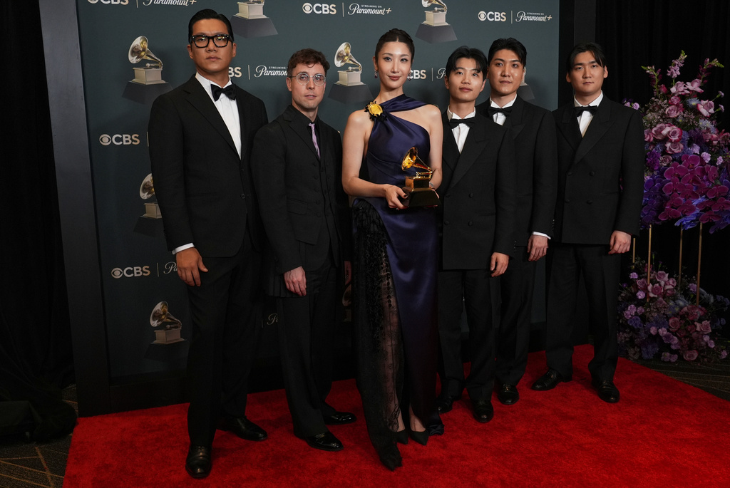 The team from "KPop Demon Hunters" pose in the press room with the award for best song written for visual media for "Golden" during the 68th annual Grammy Awards on Sunday, Feb. 1, 2026, in Los Angeles. (Photo by Richard Shotwell/Invision/AP)