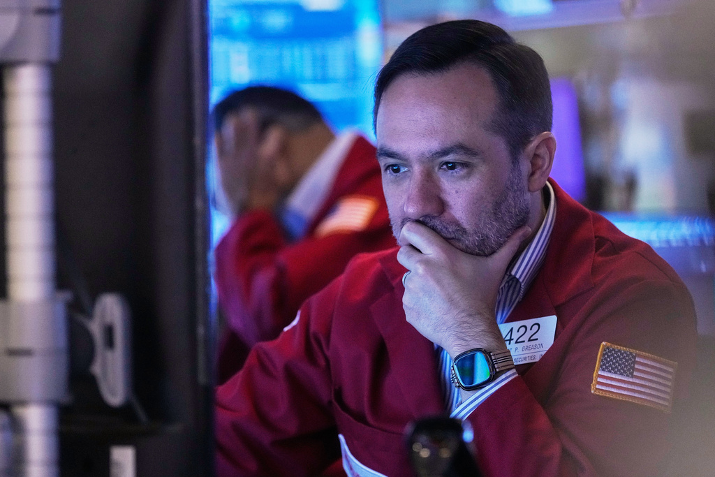 Trader Robert Greason works on the floor of the New York Stock Exchange, Friday, Nov. 14, 2025. (AP Photo/Richard Drew)