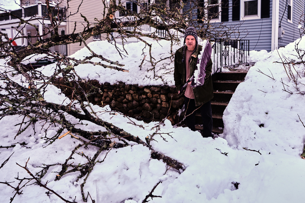 A man shovels snow after a winter storm dumped about more than two feet of snow in the region, Wednesday, Feb. 25, 2026, in Plymouth, Mass. (AP Photo/Charles Krupa)