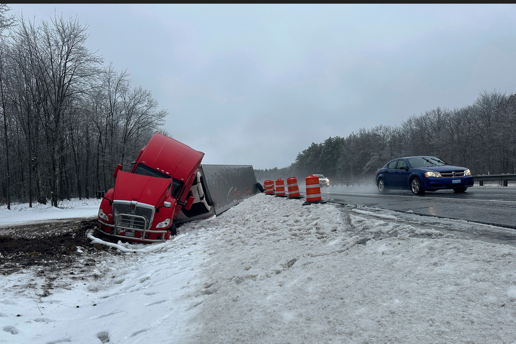 FILE - A tractor-trailer hauling a load of oranges sits on the side of the road after sliding off the Maine Turnpike early on Dec. 11, 2024, in New Gloucester, Maine. (AP Photo/David Sharp, File)