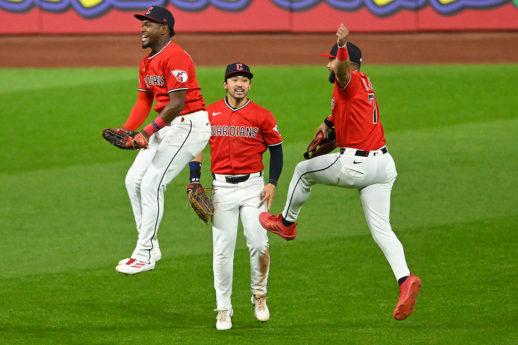 From left, Cleveland Guardians left fielder Angel Martinez, center fielder Steven Kwan, center, and right fielder George Valera celebrate a win over the Houston Astros in Cleveland, Tuesday, April 21, 2026. (AP Photo/David Richard)