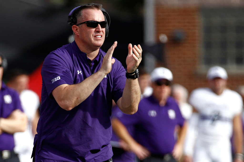 FILE - In this Oct. 14, 2017, file photo, Northwestern head coach Pat Fitzgerald claps during the first half of an NCAA college football game against Maryland in College Park, Md. (AP Photo/Patrick Semansky, File)