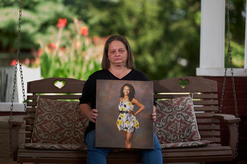 Christy Spivey poses with a portrait of her late daughter, Tasia Fortune, on Tuesday, Sept. 8, 2026, in Marion, Ky. (AP Photo/George Walker IV)