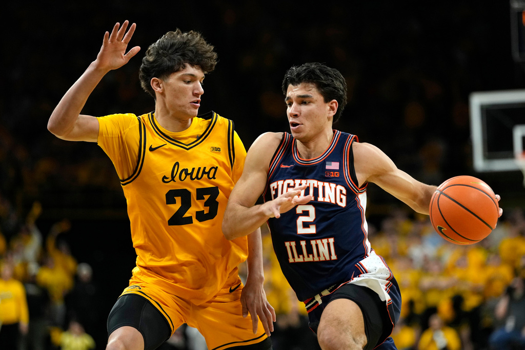 Illinois guard Andrej Stojakovic (2) drives to the basket past Iowa guard Isaia Howard (23) during the first half of an NCAA college basketball game, Sunday, Jan. 11, 2026, in Iowa City, Iowa. (AP Photo/Charlie Neibergall)