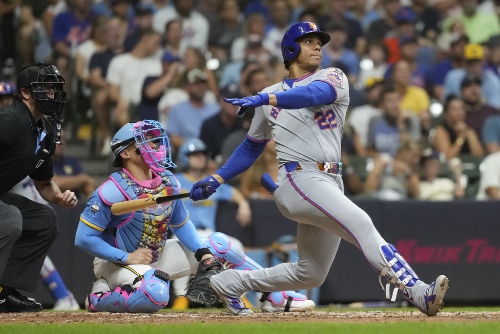 New York Mets' Juan Soto, right, watches his solo home run during the fifth inning of a baseball game against the Milwaukee Brewers, Saturday, Aug. 9, 2025, in Milwaukee. (AP Photo/Aaron Gash)