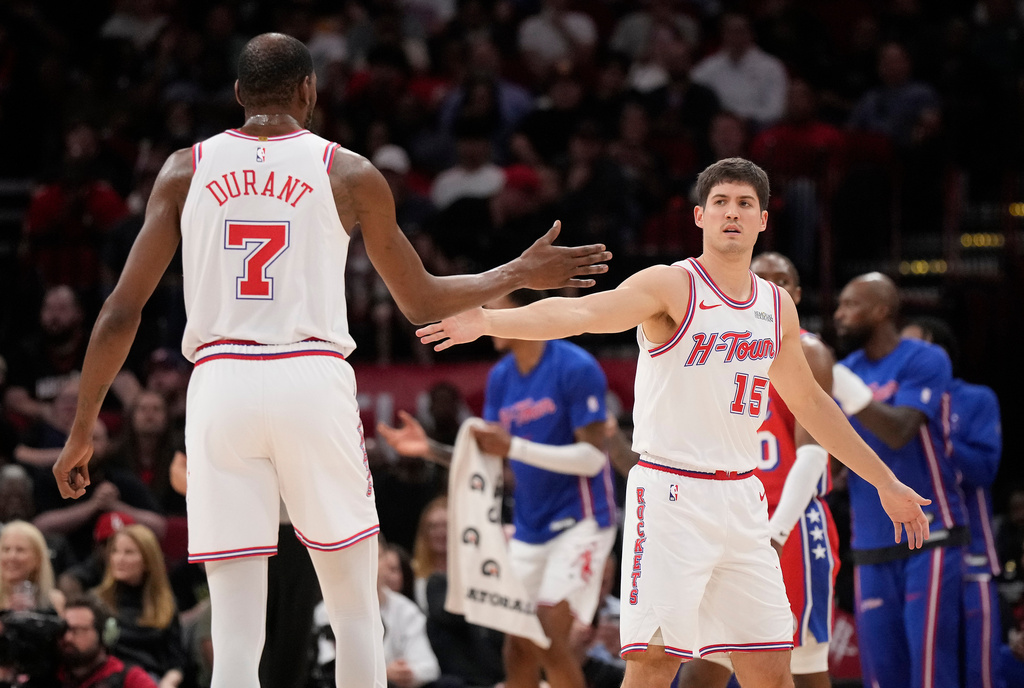 Houston Rockets' Reed Sheppard (15) celebrates one of his three point baskets with Kevin Durant (7) during the first half of an NBA basketball game against the Philadelphia 76ers, Thursday, April 9, 2026, in Houston. (AP Photo/ Karen Warren)
