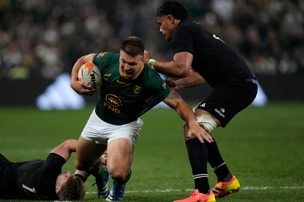 South Africa's Andr&egrave; Esterhuizen, center, is tackled by New Zealand's Jordie Barrett, left, and his teammate Tupou Vaa'i during a third international test rugby match between South Africa and New Zealand, in Johannesburg, South Africa, Saturday, Sept. 5, 2026. (AP Photo/Themba Hadebe)