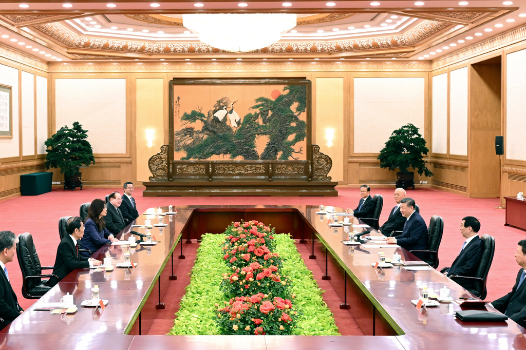 In this photo released by Xinhua News Agency, Chinese President Xi Jinping, third from right, holds talks with Kuomintang (KMT) party leader Cheng Li-wun, third from left, at the Great Hall of the People in Beijing on Friday, April 10, 2026. (Li Xiang/Xinhua via AP)