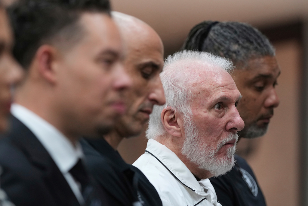 FILE - Former San Antonio Spurs head coach Gregg Popovich, second from right, sits between former players Manu Ginobili and Tim Duncan, right, as he waits to introduce Mitch Johnson, left, as the new head coach of the San Antonio Spurs NBA basketball team, in San Antonio, Monday, May 5, 2025. (AP Photo/Eric Gay, File)