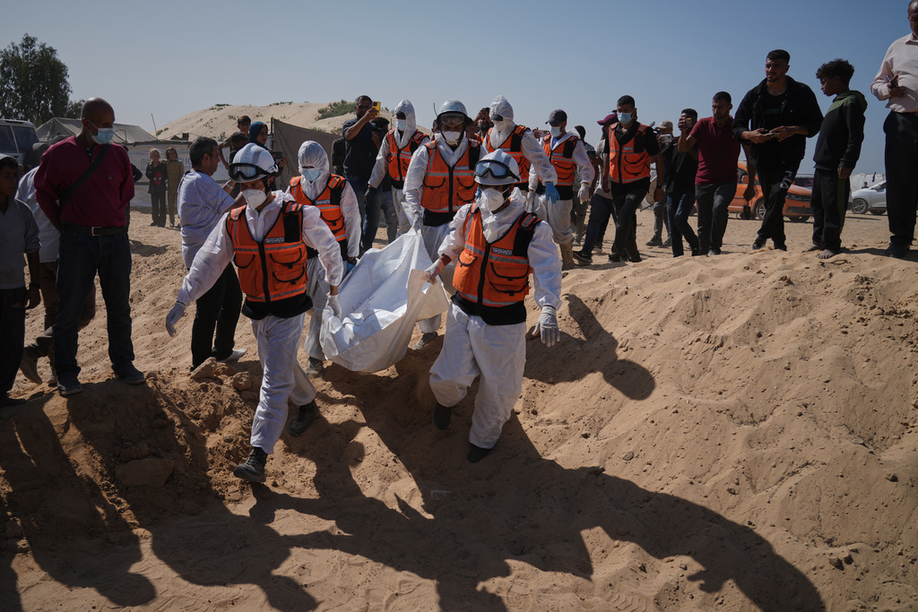Bodies of unidentified Palestinians returned from Israel as part of the ceasefire deal are buried in a mass grave in Deir al-Balah, Gaza Strip, Wednesday, Oct. 22, 2025. (AP Photo/Jehad Alshrafi)