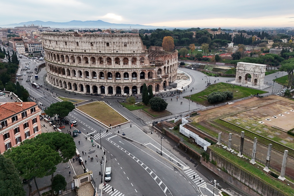 An aerial view of the Colosseum and the Arch of Titus, right, in Rome, Thursday, Dec. 4, 2025. (AP Photo/Andrew Medichini)