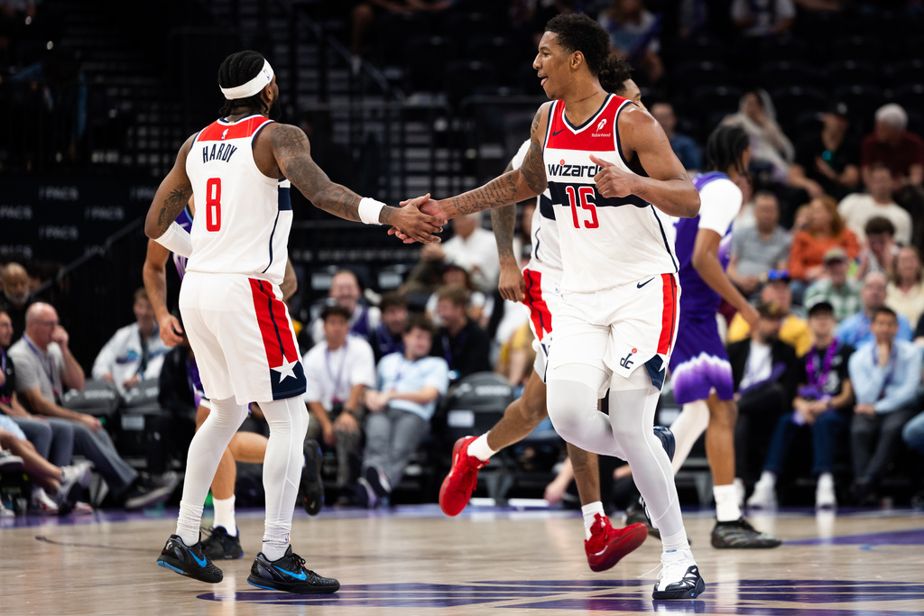 Washington Wizards forward Juju Reese (15) and Washington Wizards guard Jaden Hardy (8) high five during the second half of an NBA basketball game against the Utah Jazz, Wednesday, March 25, 2026, in Salt Lake City. (AP Photo/Anna Fuder)