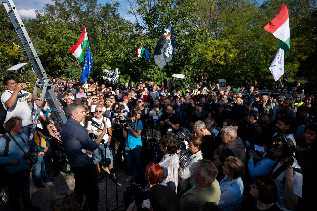 Independent lawmaker Ákos Hadházy gives a speech during a protest outside Hatvanpuszta, a country estate linked to alleged corruption involving Prime Minister Viktor Orbán, near Alcsútdoboz in Hungary, Saturday, Sept. 27, 2025. (AP Photo/Denes Erdos)