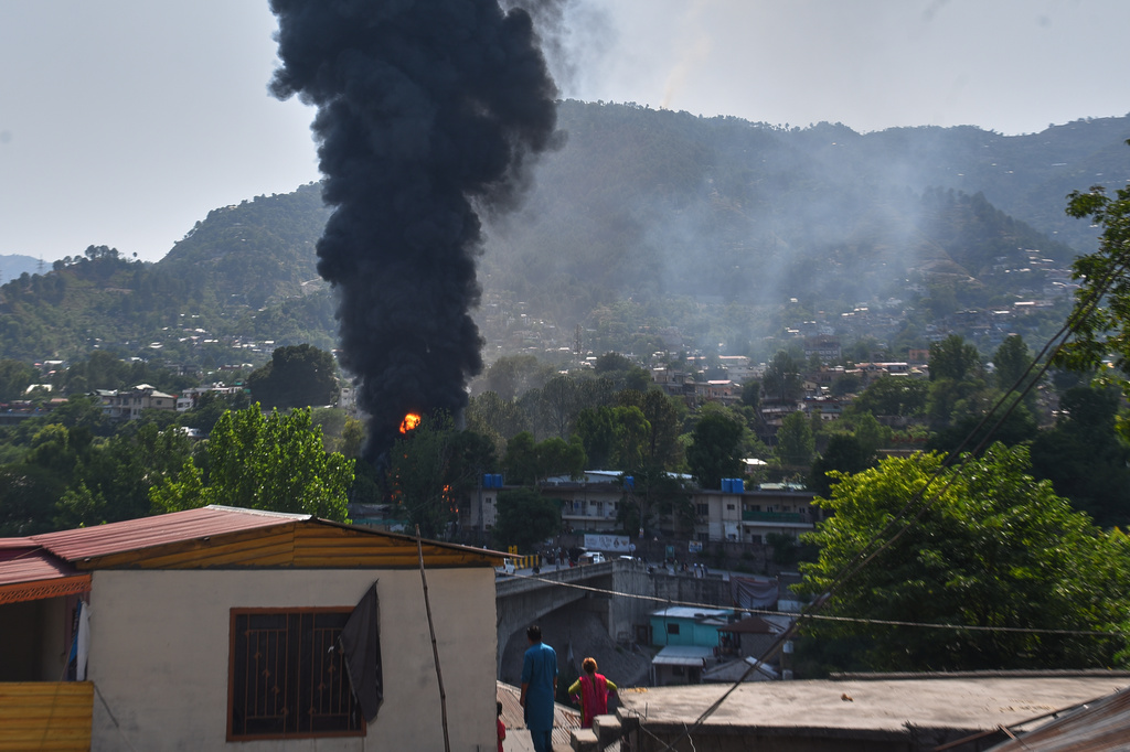 Smoke billows after an army MI-17 helicopter crashed due to a technical fault, in Muzaffarabad, capital of Pakistan-administered Kashmir, Wednesday, June 10, 2026. (AP Photo/M.D. Mughal)