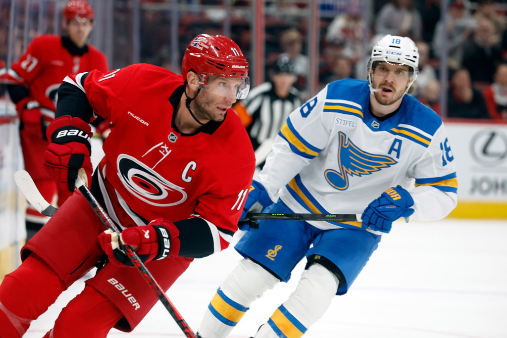 Carolina Hurricanes' Jordan Staal, left, chases the puck with St. Louis Blues' Robert Thomas, right, during the first period of an NHL hockey game in Raleigh, N.C., Thursday, March 12, 2026. (AP Photo/Karl DeBlaker)