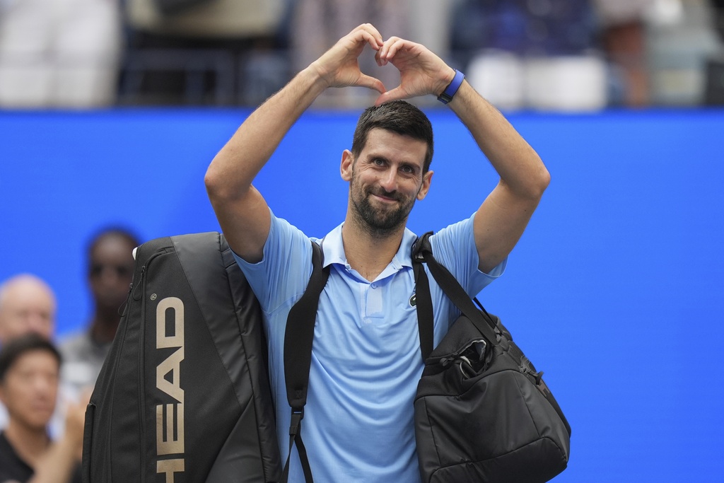 Novak Djokovic, of Serbia, acknowledges the crowd after losing to Carlos Alcaraz, of Spain, during the men's singles semifinals of the U.S. Open tennis championships, Friday, Sept. 5, 2025, in New York. (AP Photo/Seth Wenig)