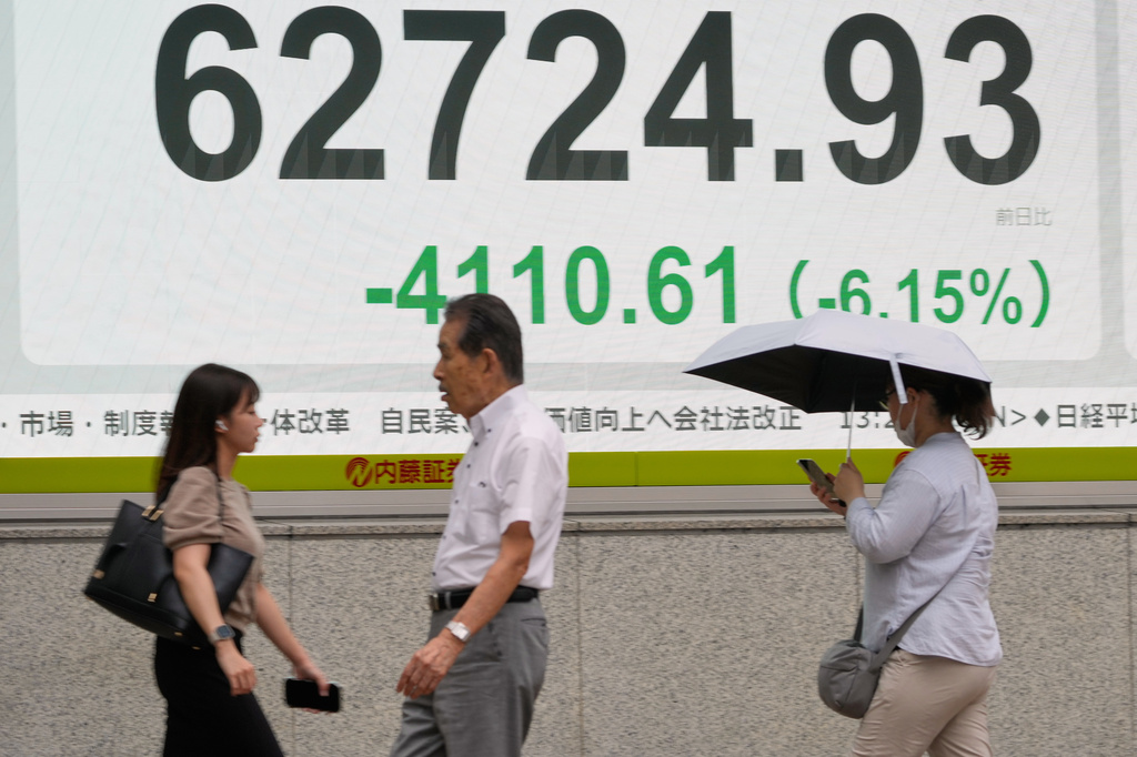 A person walks in front of an electronic stock board showing Japan's Nikkei index at a securities firm Friday, July 17, 2026, in Tokyo. (AP Photo/Eugene Hoshiko)