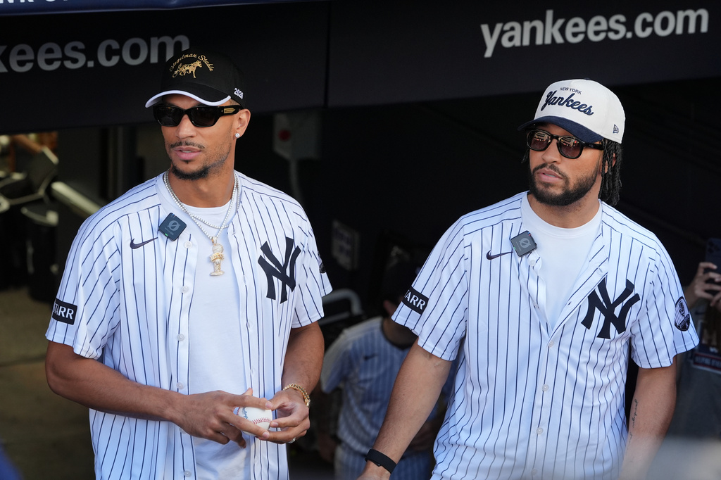 New York Knicks' Josh Hart, left, and Jalen Brunson, right, wait to throws out a ceremonial first pitch before a baseball game between the Chicago White Sox and the New York Yankees Wednesday, June 17, 2026, in New York. (AP Photo/Frank Franklin II)