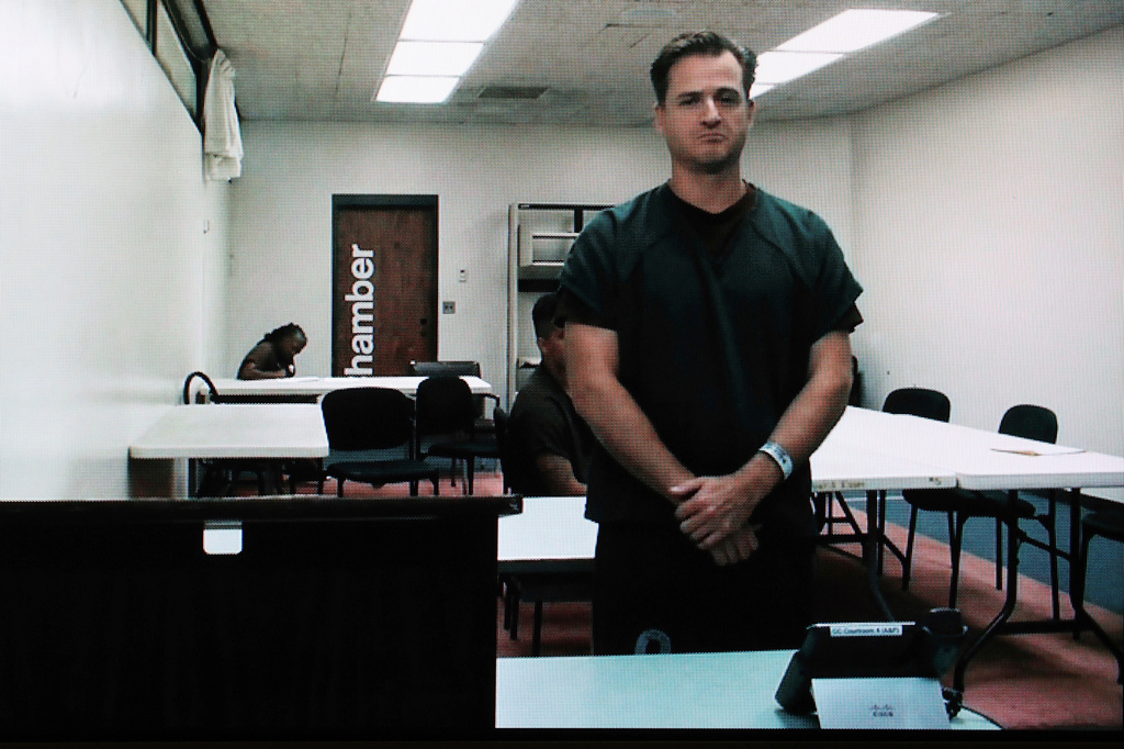 FILE - Hawaii doctor Gerhardt Konig appears before a judge via video during an arraignment hearing after being indicted on allegation of attempting to kill his wife, April 7, 2025, in Honolulu. (AP Photo/Marco Garcia, File)