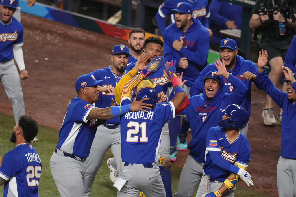 Venezuela Ronald Acuña Jr. (21) celebrates after scoring during the seventh inning of a World Baseball Classic semifinal game against Italy, Monday, March 16, 2026, in Miami. (AP Photo/Lynne Sladky)